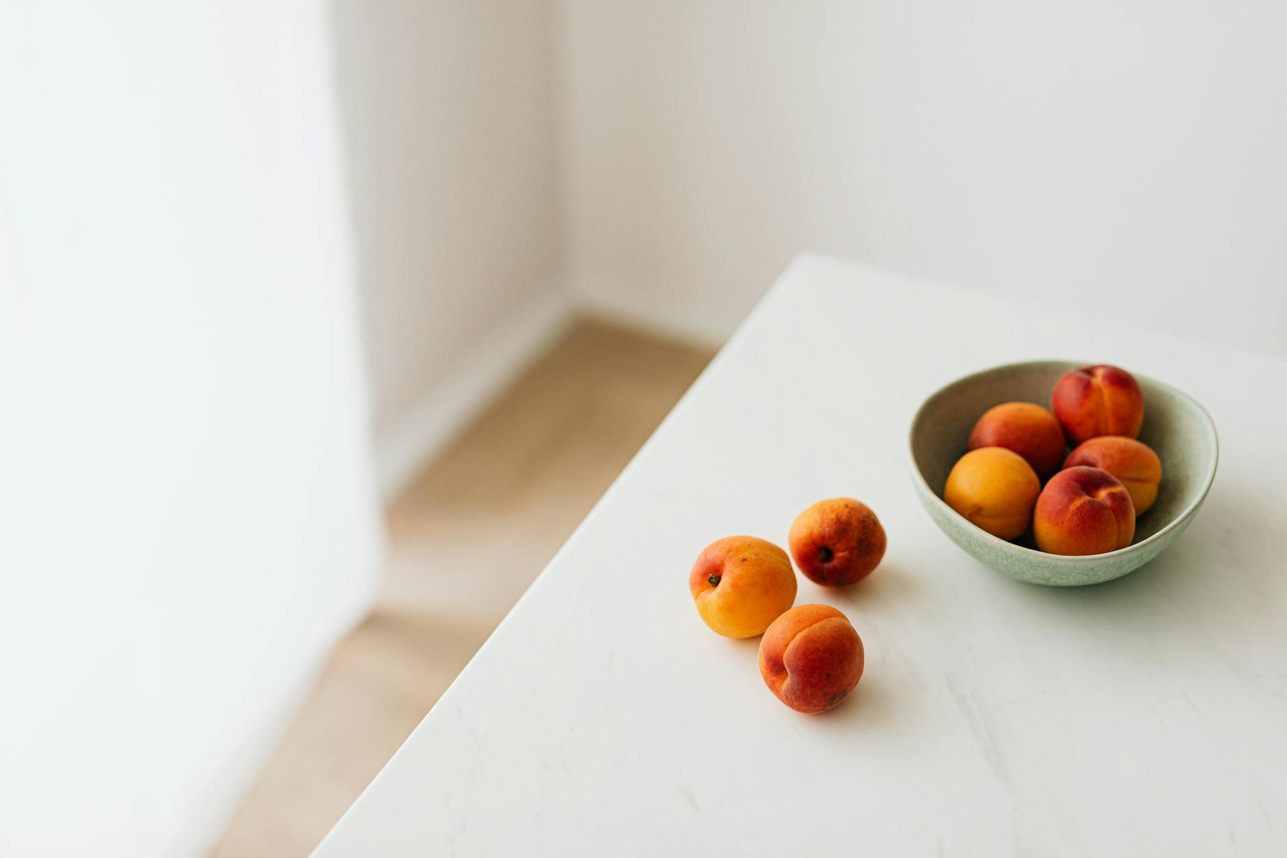 Fresh apricots in a minimalist setting, showcasing a healthy vegan snack.