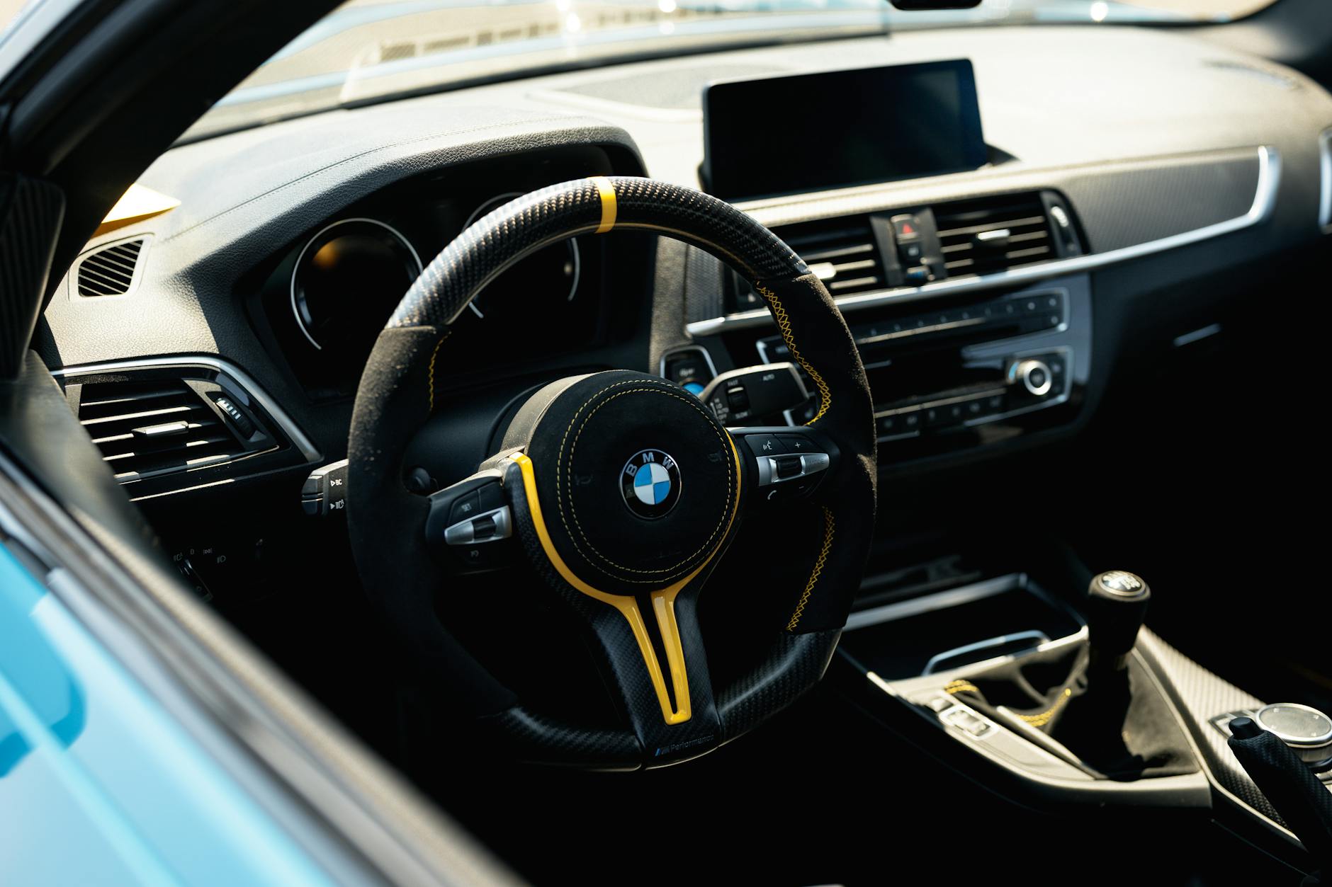 Explore the intricate details of a BMW car interior, showcasing luxury and design with a focus on the steering wheel.