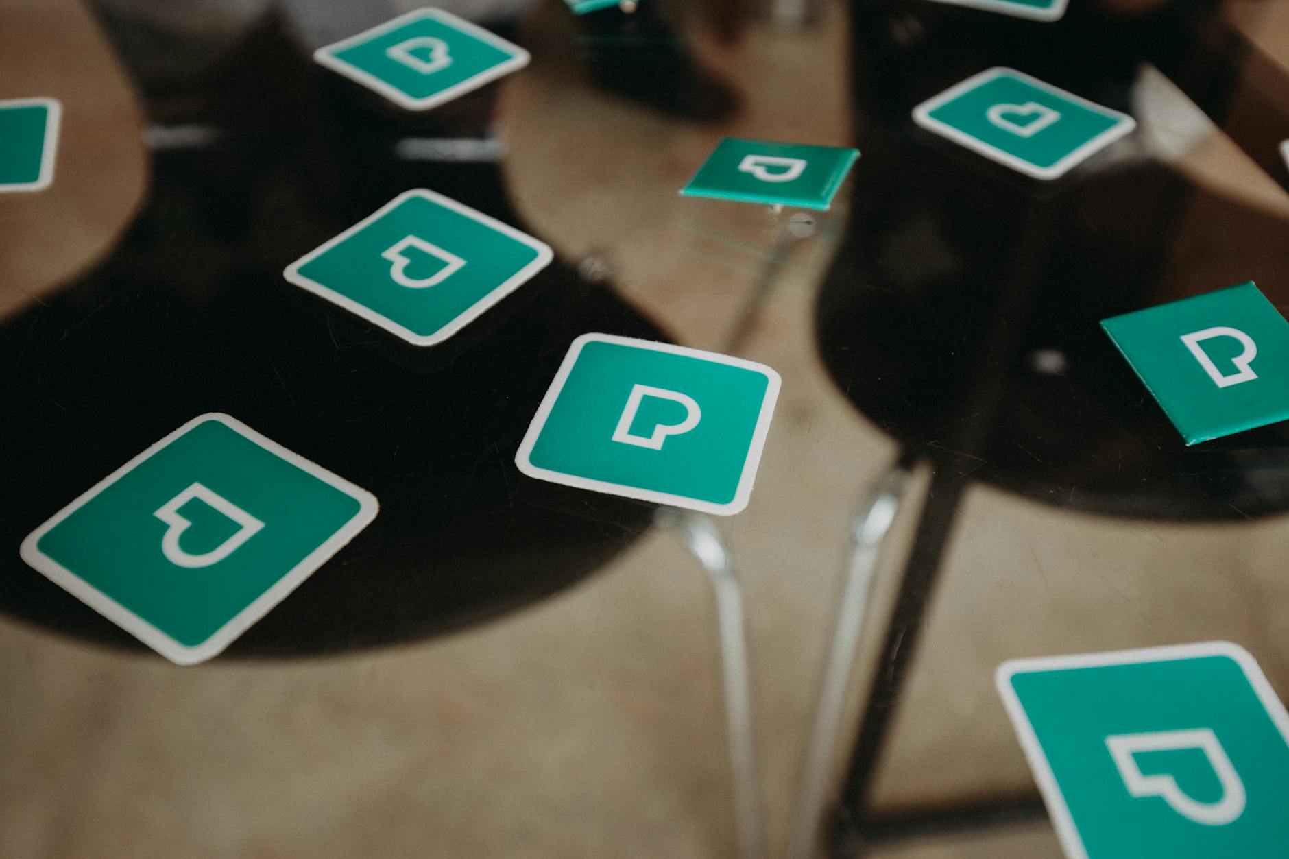 Close-up of game cards scattered on a transparent glass table, focusing on play and strategy concepts.